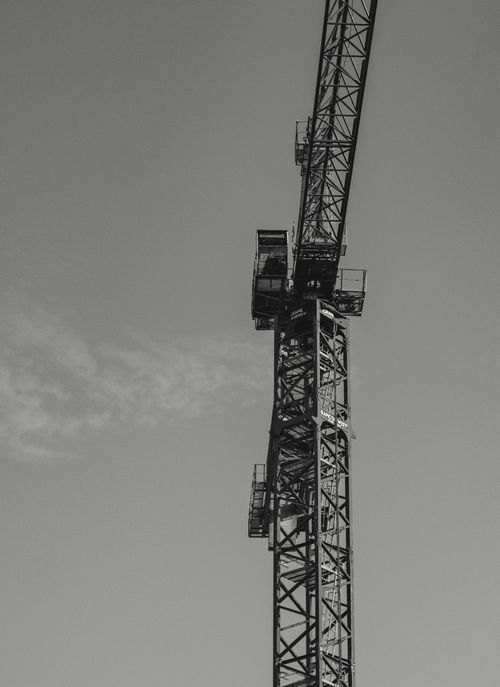 Free Black and white tower crane in Vancouver, BC, captured with low angle shot conveys construction theme. Stock Photo