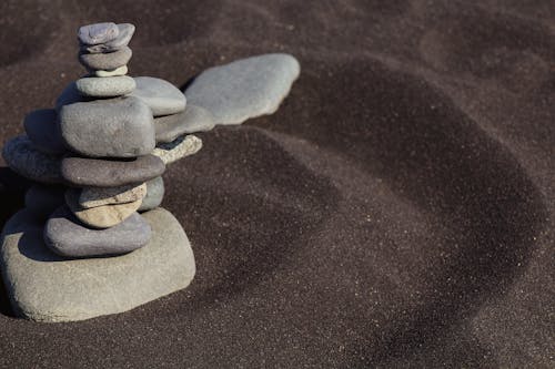 Photograph of a Stack of Stones on Sand