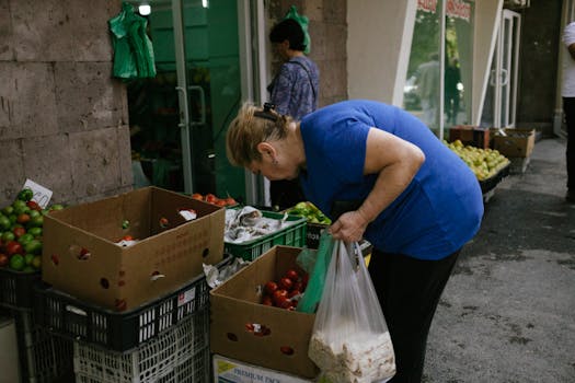 Woman selecting fresh produce at an outdoor market in Yerevan, Armenia.