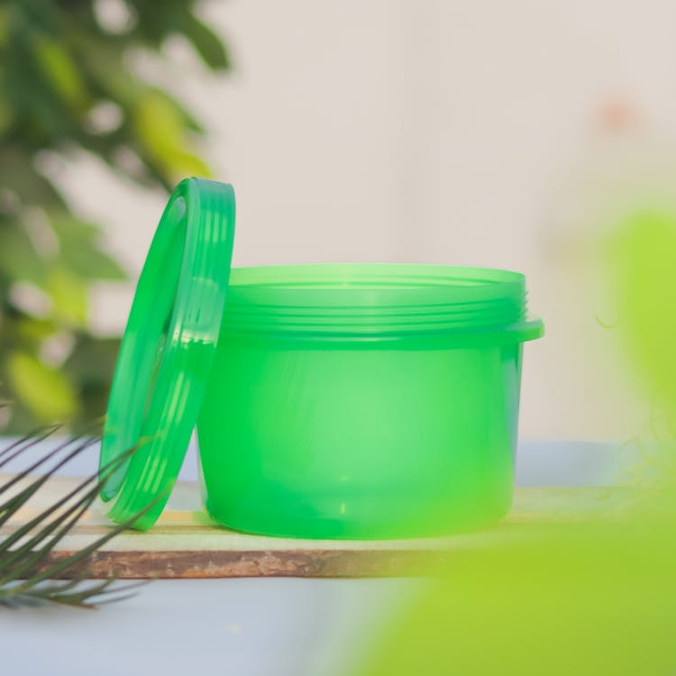 A Green Plastic Container With Lid