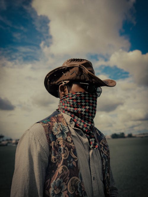 Man in Cowboy Hat and Mask Outdoors