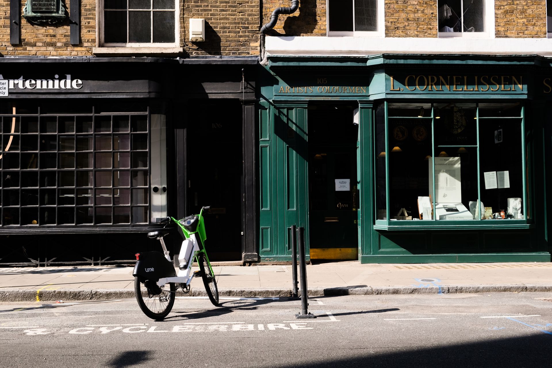 Charming vintage storefront with an electric bike parked on a quiet city street.