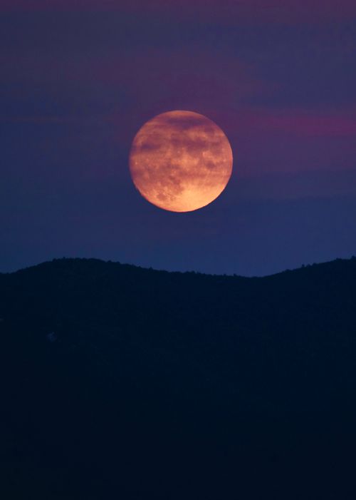 Free Breathtaking full moon rising over the silhouette of Albanian mountains at night. Stock Photo