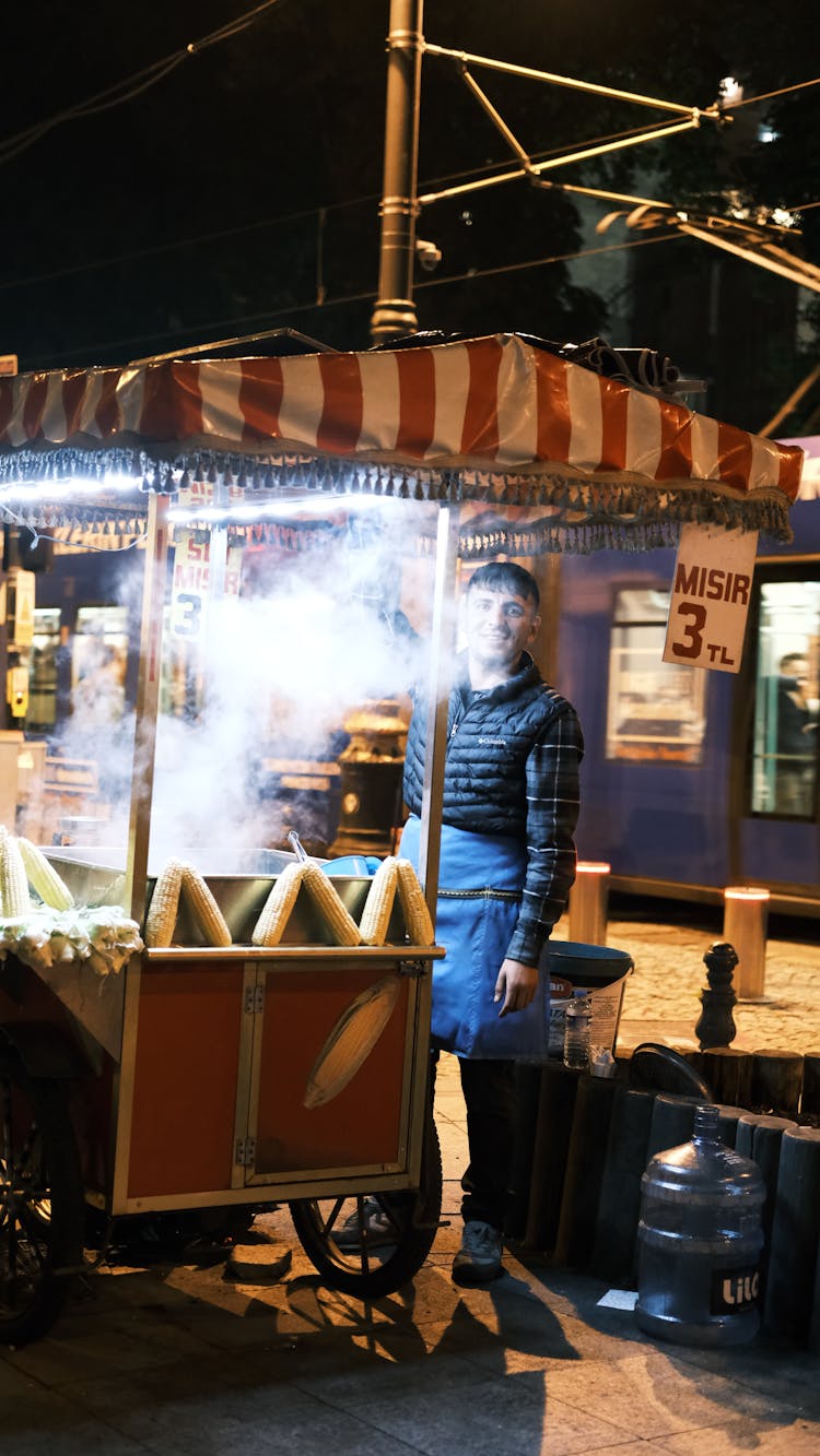 Man Working At Food Stand At Night