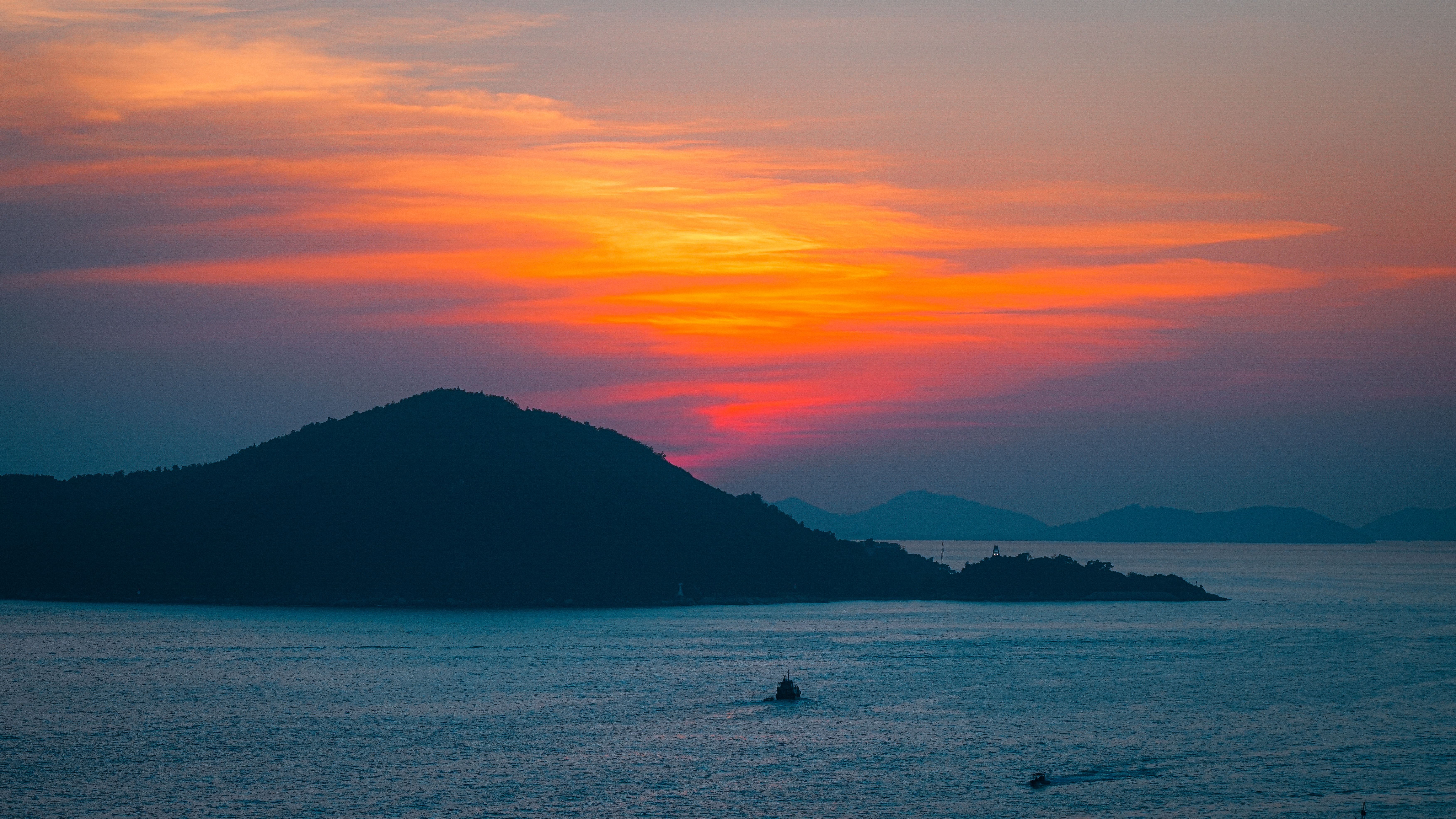 Stunning sunset view over an island in Hong Kong, featuring vivid colors and tranquil waters.