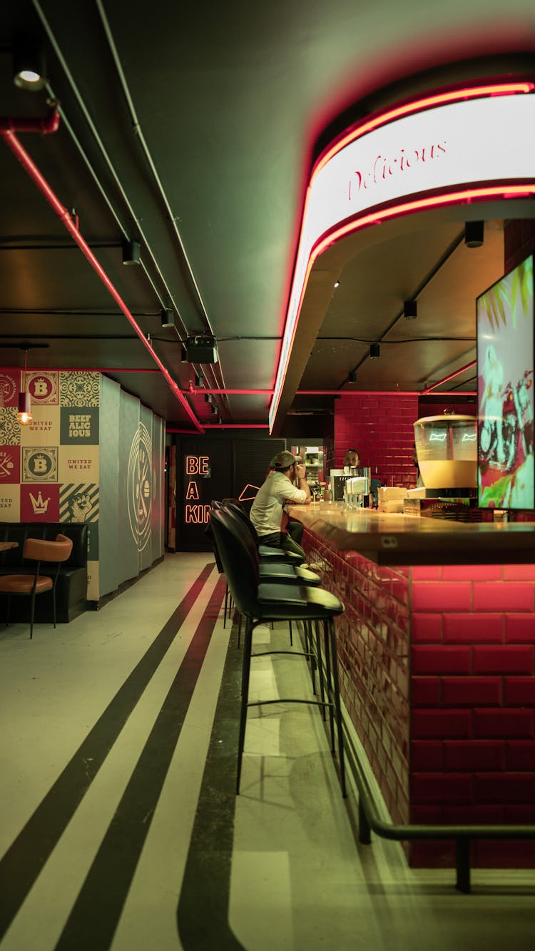 A Person Sitting Alone At A Bar