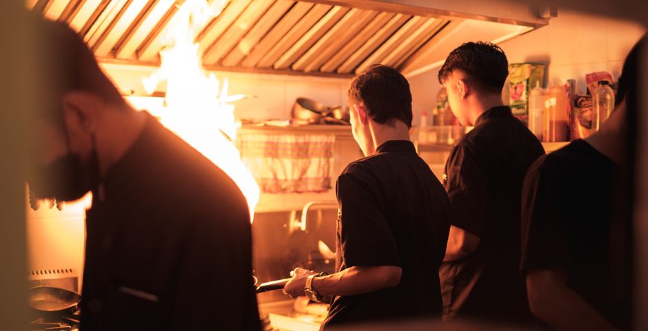 Chefs working in a busy industrial kitchen — a standard treatment protocol lets any technician service any outlet