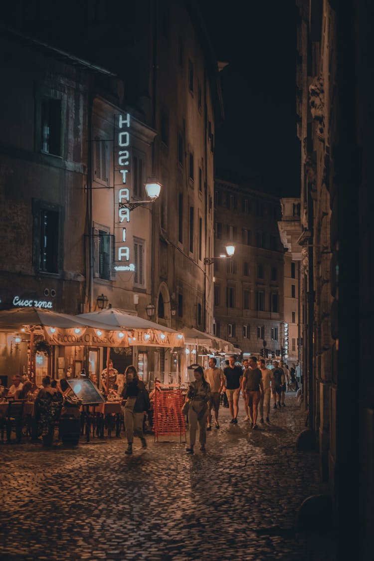 People Walking On Street During Night Time