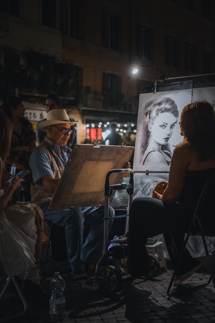 Man On A Street Drawing Portraits Of People 