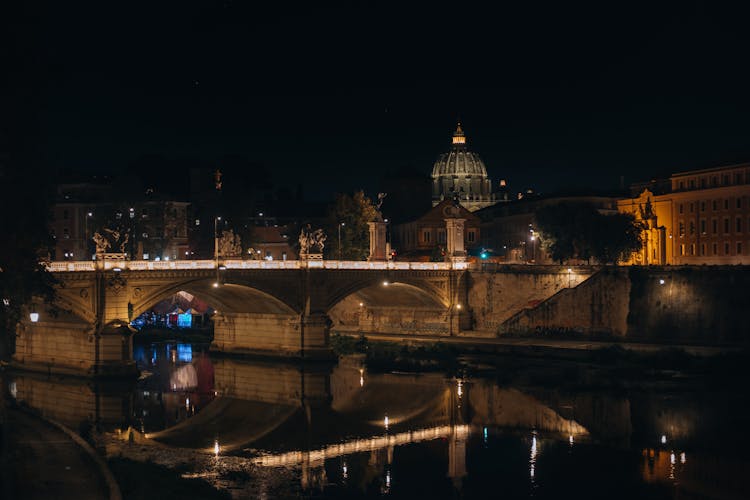 Iluminated Buildings Around River At Night