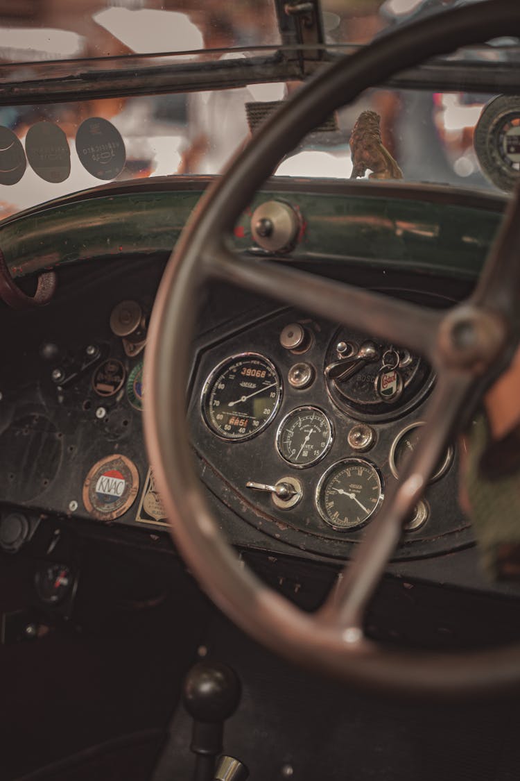 Closeup Of A Vintage Car Steering Wheel And Dashboard