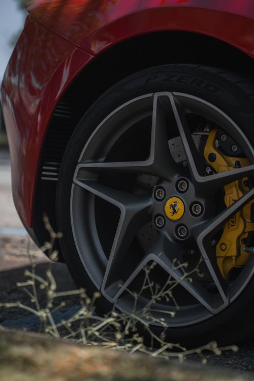 Free Detailed view of a red sports car's wheel showcasing tire and brake. Stock Photo