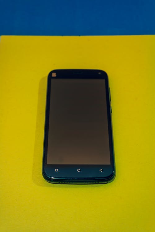 HTC Smartphone Lying on Yellow Background