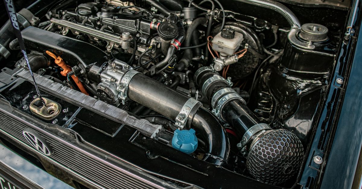 Close-up of a high-performance car engine under an open hood, showcasing mechanical details and engineering excellence.