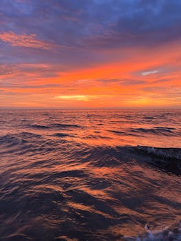 A breathtaking sunset over the ocean with vibrant colors and serene waves.