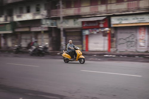 A Man Riding a Motor Scooter