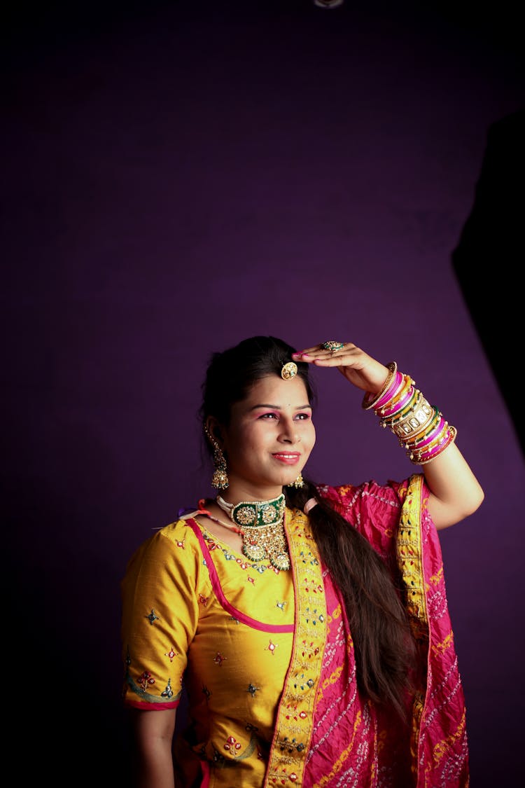 Woman In Traditional Dress Posing In Studio