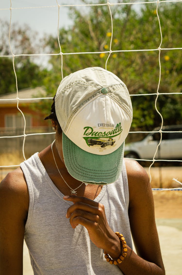 Photo Of A Boy With A Cap Looking Down