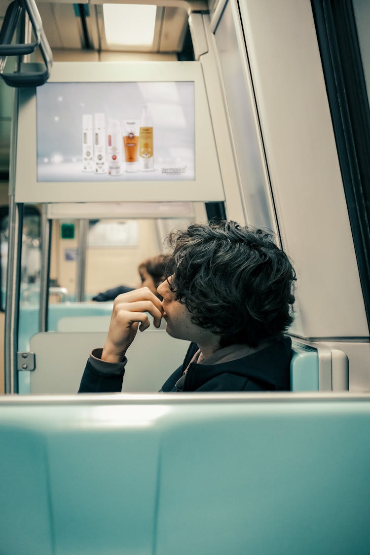 A Man Sitting On A Train