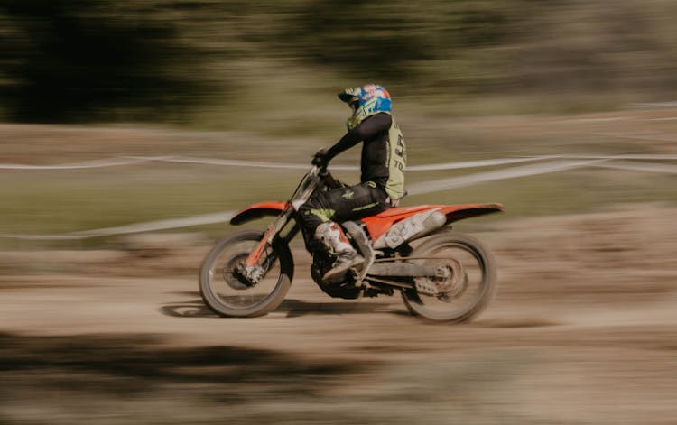 A Man Riding Red Motorcycle