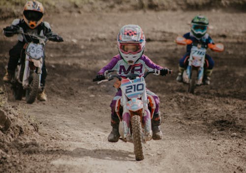 Children in Uniforms Riding Motorbikes