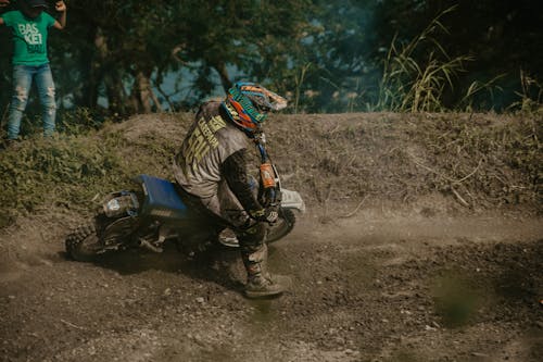 Man Riding on a Dirt Bike on a Trail 