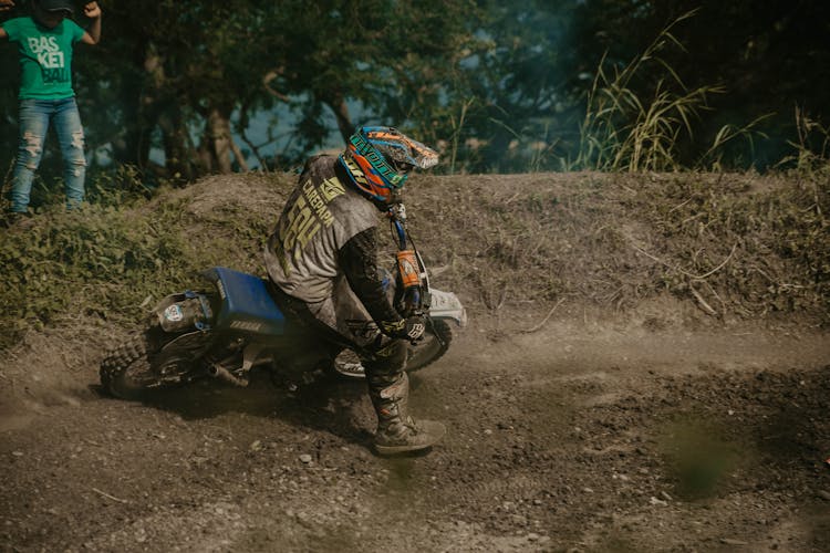 Man Riding On A Dirt Bike On A Trail 