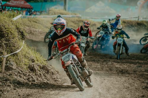 Free Exciting motocross competition featuring racers navigating a challenging dirt track. Stock Photo