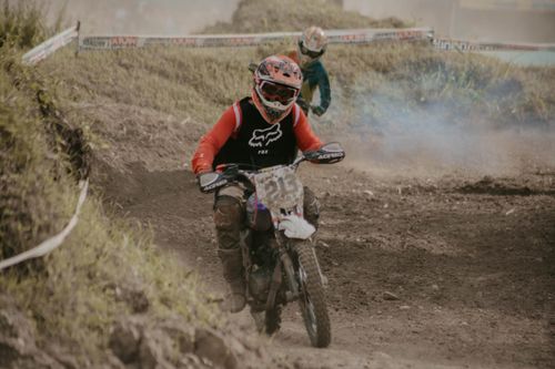Free Action-packed motocross competition with riders racing on a challenging dirt track. Stock Photo
