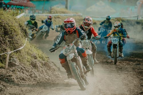 Free Exciting off-road motorcycle race with multiple riders navigating a dirt track. Stock Photo
