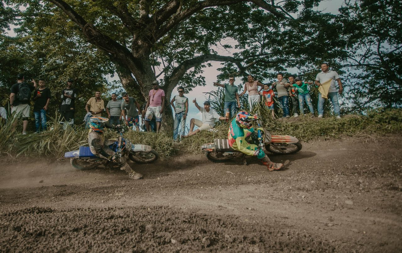 exciting motocross race with two riders competing on a dirt track surr