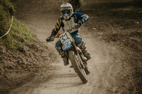 Free Skilled motocross rider speeding on a dirt track during a thrilling race event. Stock Photo
