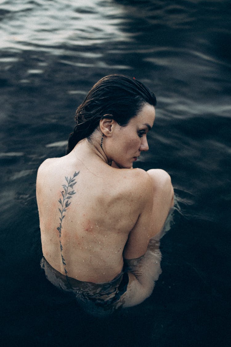 A Topless Woman In Water