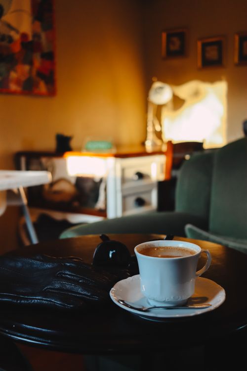 Free Warm coffee cup on table in a cozy Ankara café interior setting. Stock Photo