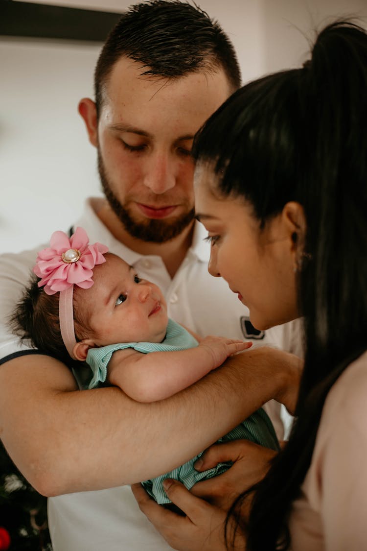 A Man And A Woman With Their Baby