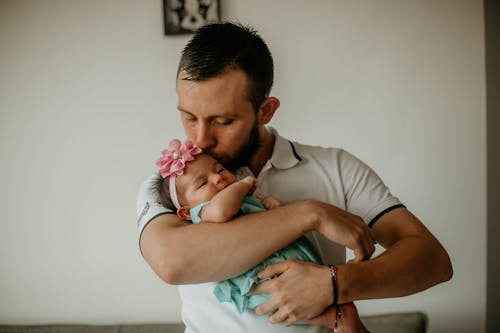 Free Photograph of a Father Kissing His Daughter Stock Photo
