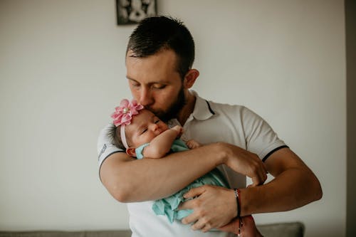 Photograph of a Father Kissing His Daughter