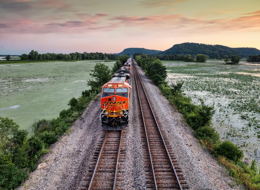 Aerial View of a Train on Railway at Sunset 