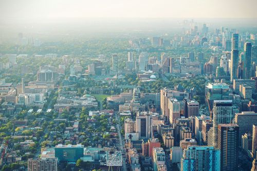 Free Stunning aerial view of a bustling cityscape with skyscrapers and green spaces. Stock Photo