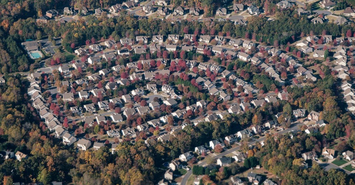Aerial shot of a circular neighborhood in Fort Mill, SC, showcasing fall foliage and suburban layout.