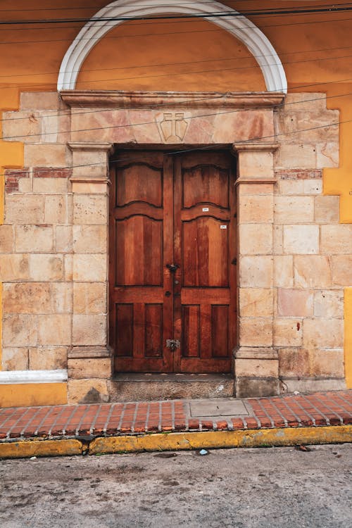 A Wooden Door Between Concrete Wall