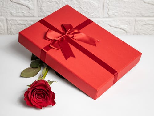 Free A Red Gift with Red Ribbon and Red Rose Stock Photo