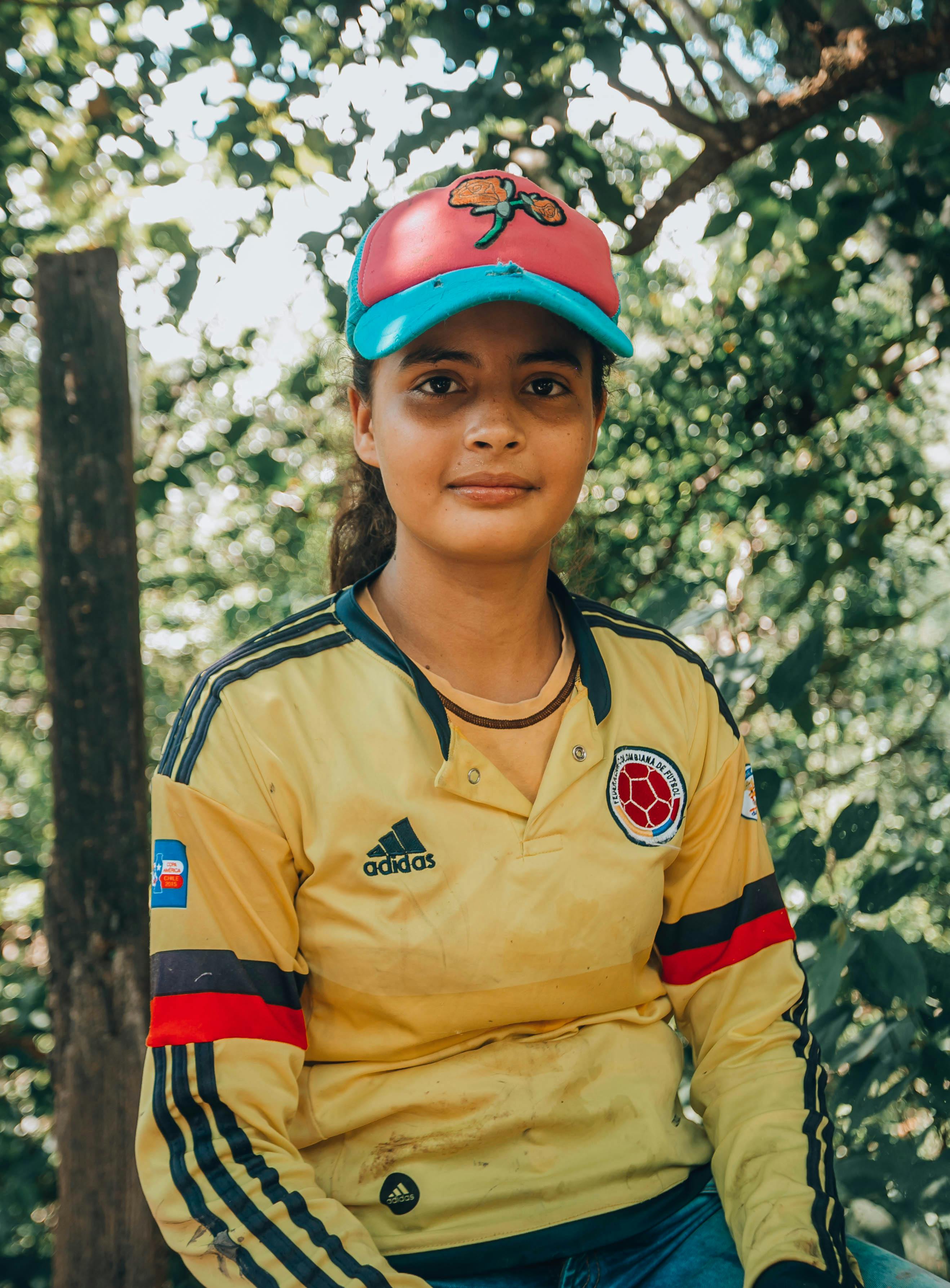 a woman in yellow and black long sleeve shirt
