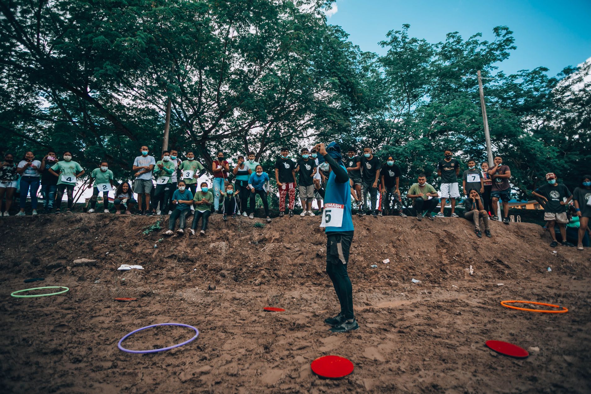 A lively outdoor event with participants and spectators, highlighting teamwork and community spirit.