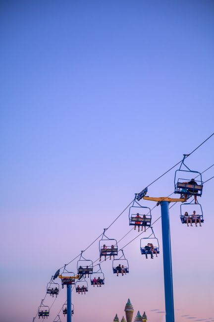 A captivating view of a sky ride under a clear sunset sky, perfect for leisure and recreation.