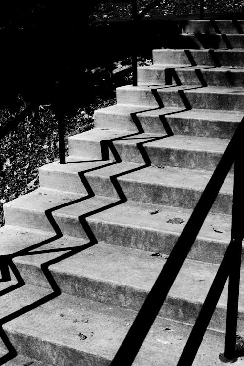 Grayscale Photo of Concrete Staircase