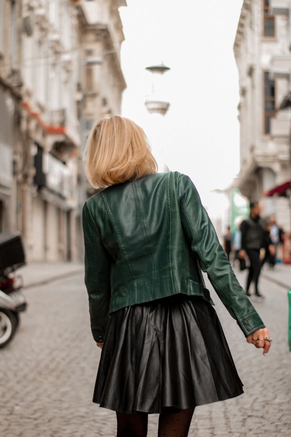 Woman in leather jacket with culottes and pointed flats