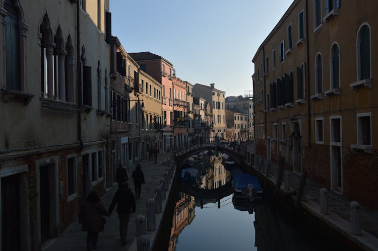 People Walking Venetian Street Near Canal