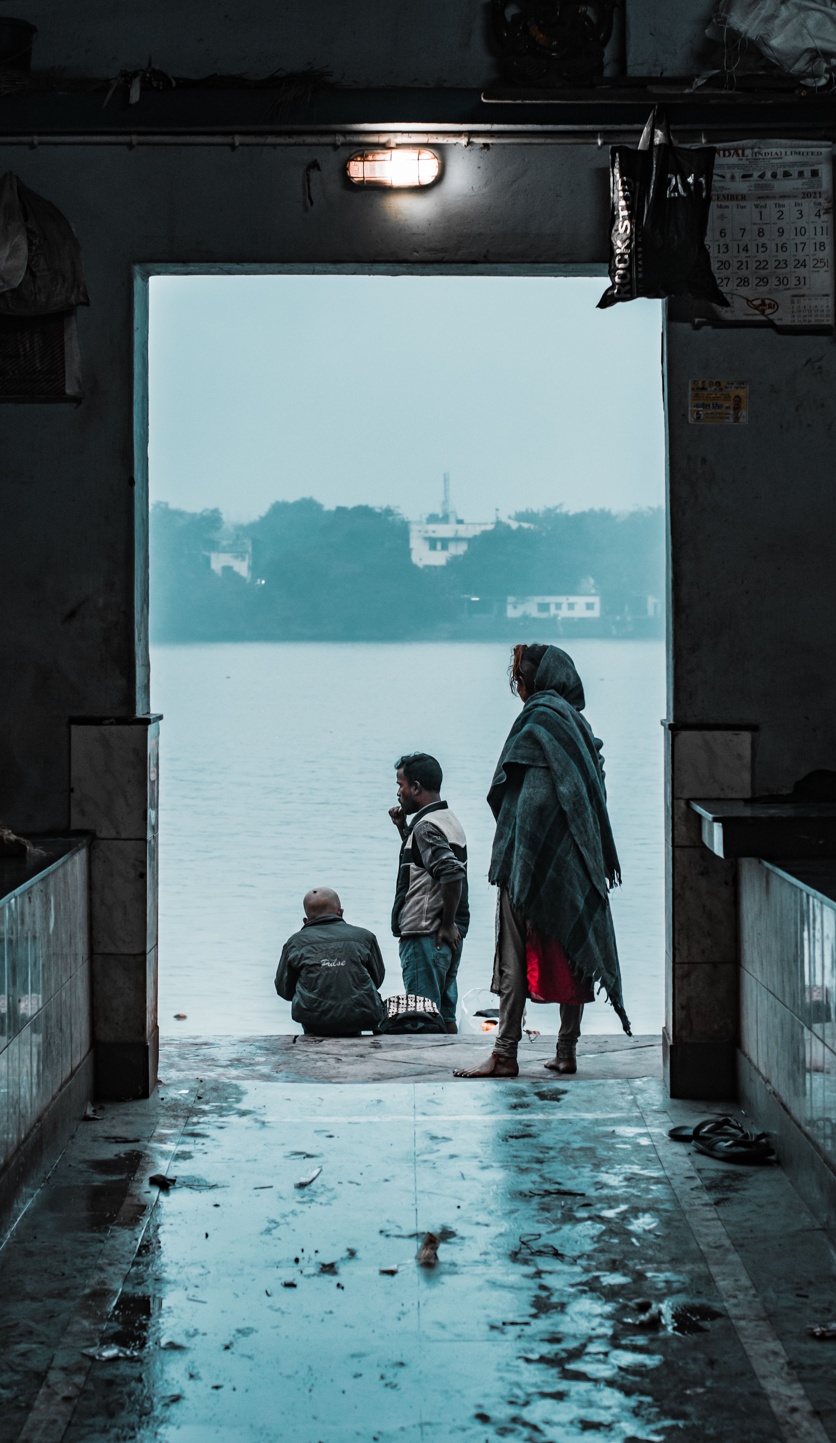 Man and Woman Standing in the Entrance of a Building on a Seashore ...