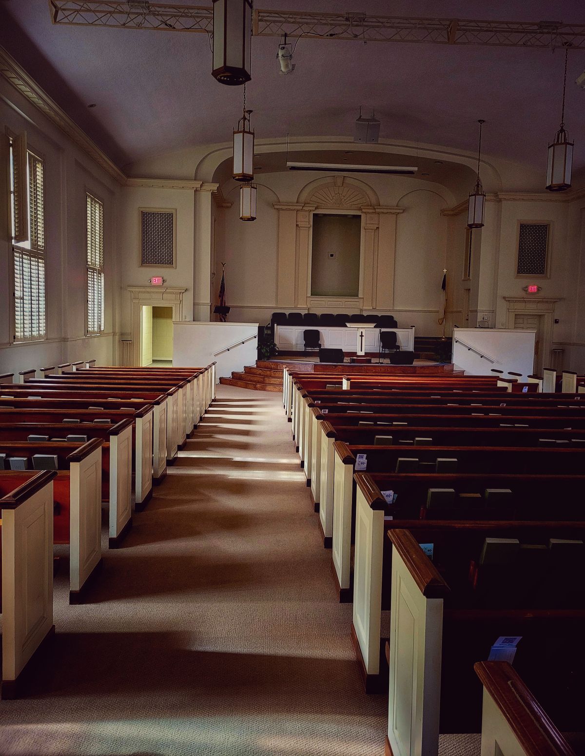 Clean place of worship interior with pews